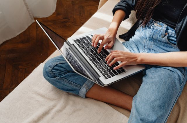 Woman using a laptop to troubleshoot internet issues with Tuckersmith Communications.